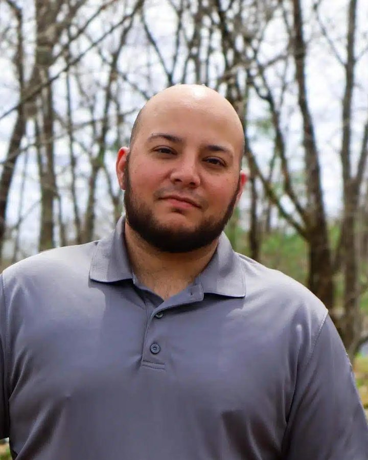 Michael Tello, board member of Veterans Resource Alliance, outdoors in a grey polo shirt